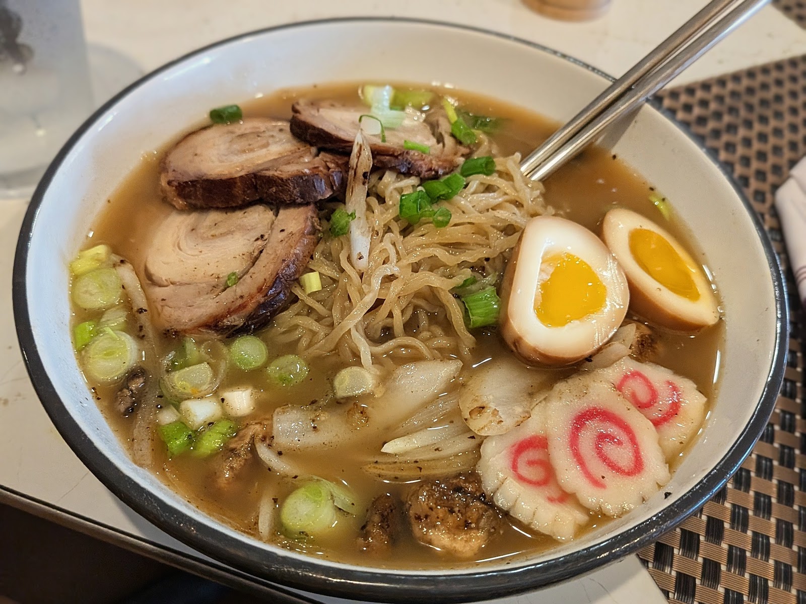 Ramen bowl with corn, potato, celery and lime, served tableside