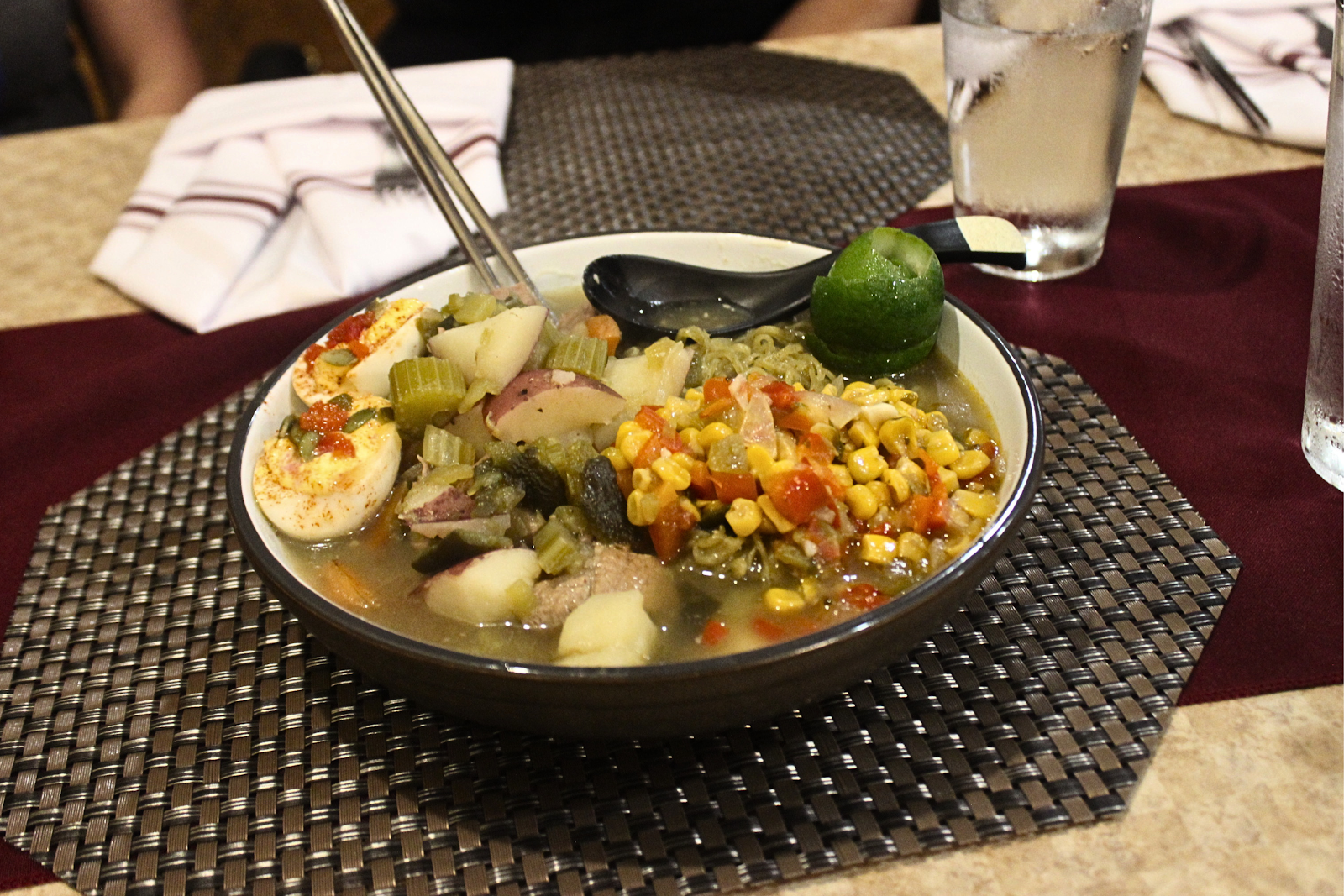 Fusion ramen bowl with handmade noodles, seasoned egg, and fresh vegetables at The Brutumus Fuse Box