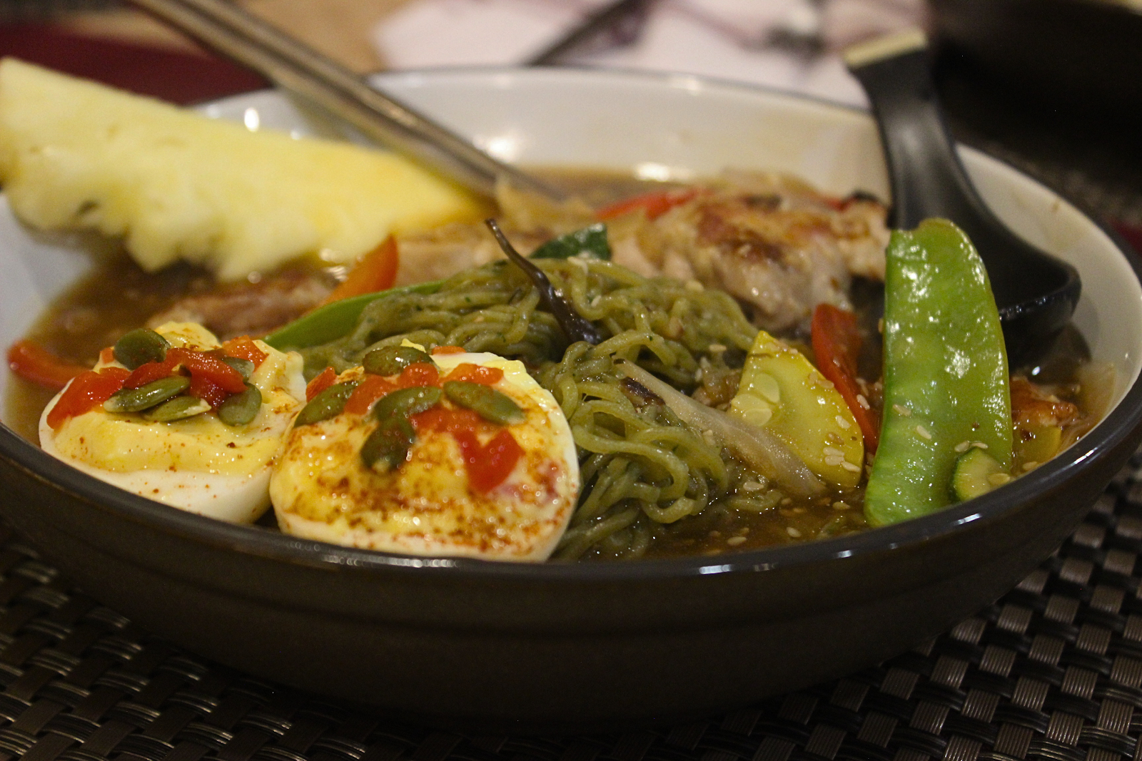 Detail shot of tajin deviled eggs over noodles and vegetables